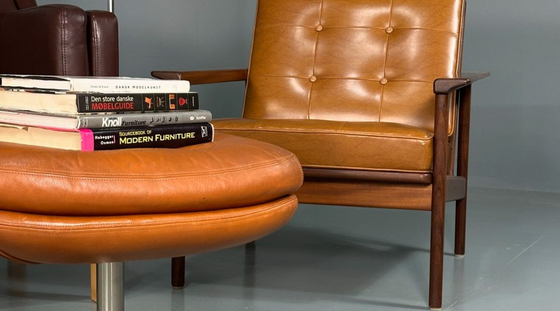 Tan leather vintage chair with mid-century modern tabletop books