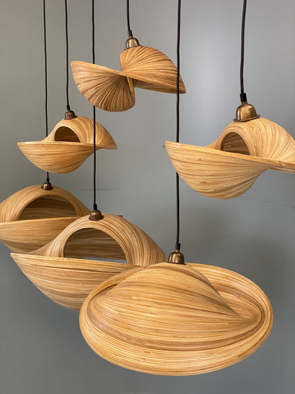 Bamboo pendant light fixture with shell-like design on a grey background
